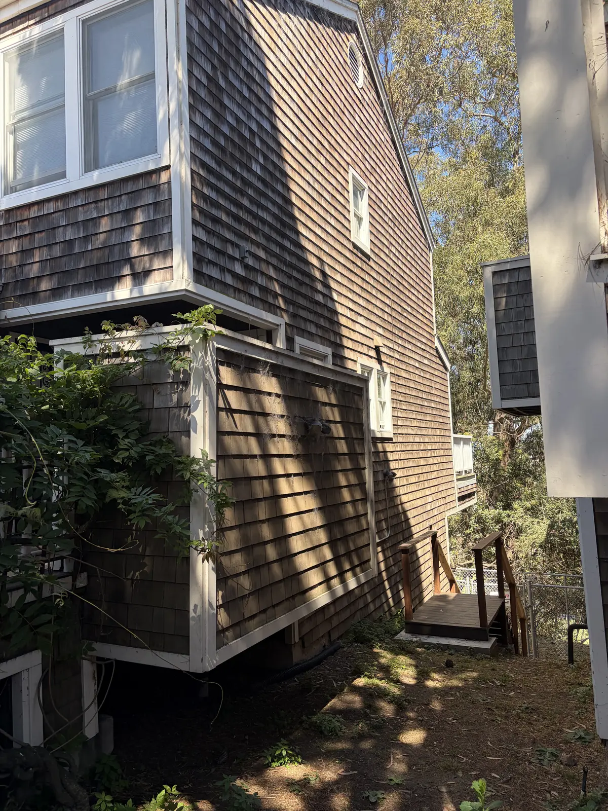 Before: weathered cedar shingle siding, dulled and dirty